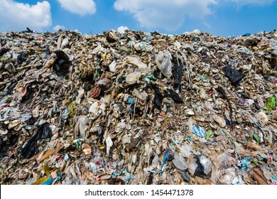 Fluffy Clouds And Blue Skies Over Large Garbage Mountain Ranges That Was Sent From Urban Communities And Industrial Areas This Is An Environmental Problem In The 3rd World Countries, Southeast Asia.
