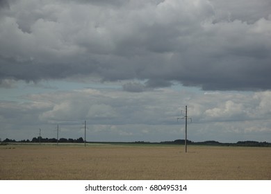 Fluffy clouds over the field