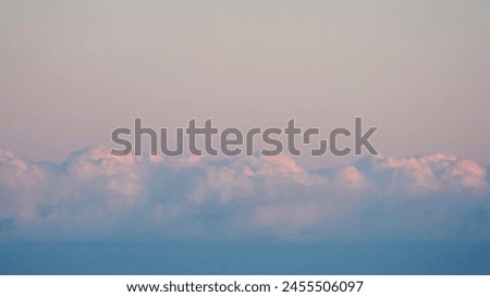 Fluffy clouds sunset sky above calm sea with space for text. Miminal coastal banner.           