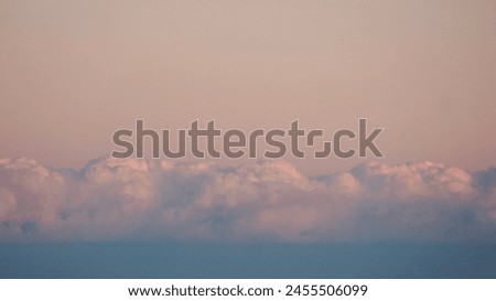 Fluffy clouds sunset sky above calm sea with space for text. Miminal coastal banner.           