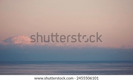 Fluffy clouds sunset sky above calm sea with space for text. Miminal coastal banner.           