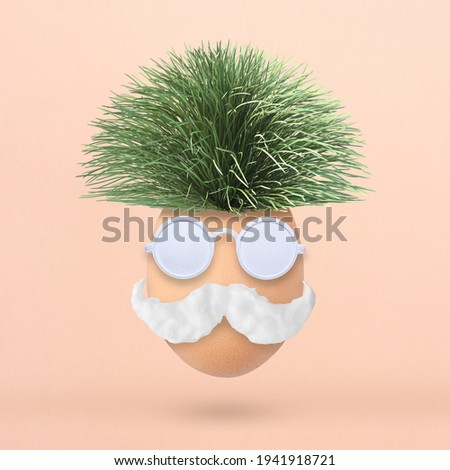 Fluffy creative Easter egg made of green grass, sunglasses and mustache on pastel pink background. Minimal spring concept. Flat lay.