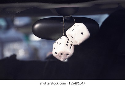 Fluffy Dice Hanging Off The Rear View Mirror Of A Car, Boy Racer Style.