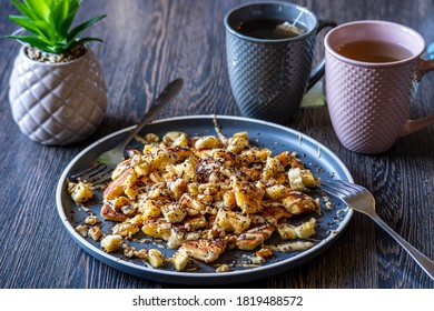 Fluffy, Gluten-free, Shredded Pancake / Kaiserschmarrn Served With Halvah Spread, Banana, Walnuts, And Grated Chocolate Placed On A Decorative Plate And Teacups At The Background