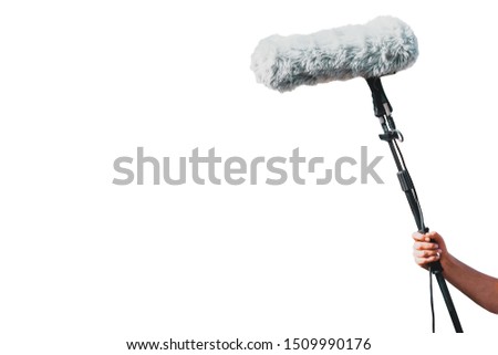 Fluffy microphone in men's hand isolated on a white background. Windsock for recording audio in windy weather. Video production on TV. Moviemaking