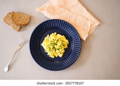 Fluffy Scrambled Eggs Recipe With Bread On Side. Top View.