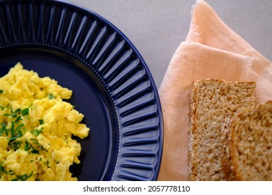 Fluffy Scrambled Eggs Recipe With Bread On Side. Top View.