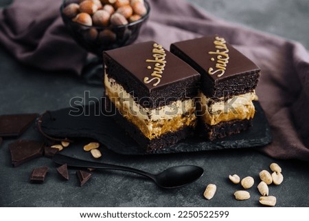 Fluffy snickers cake on stone board