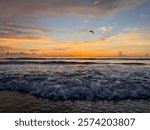 Fluffy waves and warm sunrise and layered clouds in Daytona Beach, Florida