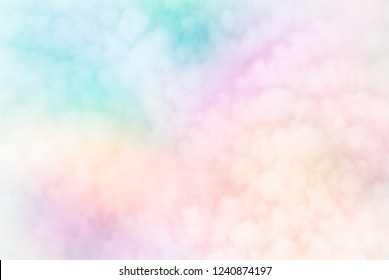 Fluffy white blurred sky clouds on abstract neon pastels of rainbow patchwork  background - Fleecy sky (Cirrocumulus - weather forecast cloud type) brings change.