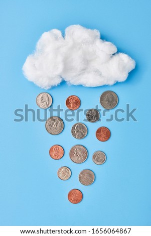 a fluffy white cloud raining coins