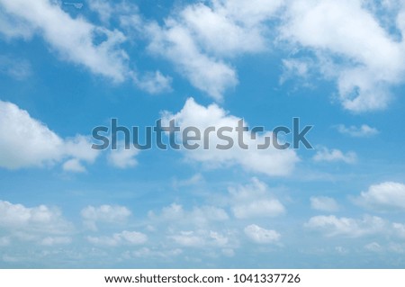 Fluffy white clouds and blue sky background
