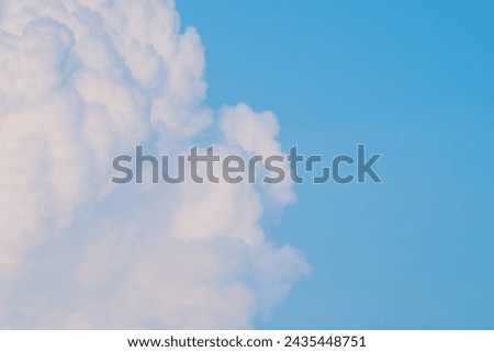 ,Fluffy white clouds on a clear blue sky. Amazing phenomena of natural phenomena, weather, with copy space for artwork.