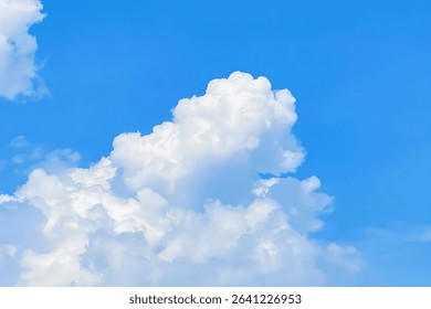 Fluffy white cumulus clouds float against a vibrant blue sky, creating a serene and calming atmosphere. The focus is on the cloud formations.