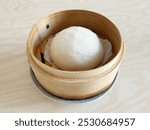 Fluffy and white pao steamed in a bamboo steamer