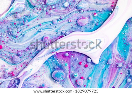 Fluid art texture. Backdrop with abstract iridescent paint effect. Liquid acrylic artwork that flowing bubbles. Mixed paints for website background. Aquamarine, purple and white overflowing colors.