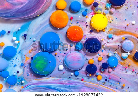 Fluid art texture. Background with abstract mixing paint effect. Liquid acrylic picture that flowing bubbles. Mixed paints for background or poster. Bright overflowing colors.