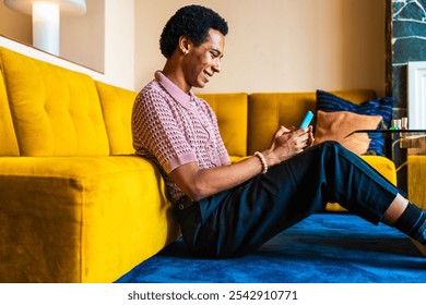 Fluid gender young man wearing cross dressing clothing at home, LGBTQ and diversity concepts - Hispanic non binary male portrait in a colorful apartment, LGBT people concepts - Powered by Shutterstock