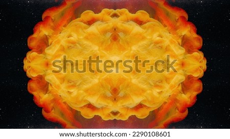 Fluid kaleidoscope. Paint water. Ink drop. Yellow red orange color smoke cloud explosion symmetrical pattern on dark black glitter texture abstract background.