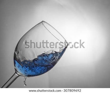 Fluid motion of coloured water in a wine glass 