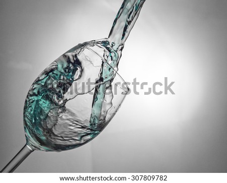 Fluid motion of coloured water in a wine glass
