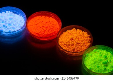 Fluorescent organic materials powder of red, yellow, green color for production OLED inside of glasses bottles in UV light. - Shutterstock ID 2146456779