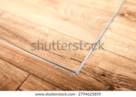 Flush mounted trapdoor panel in indoor wooden floor