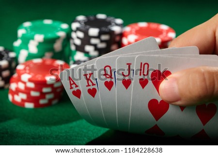 Flush royal in poker player hand. Lucky winner.