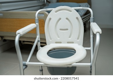 Flush Toilet And Shower Chair In Bathroom For Old Elder People.