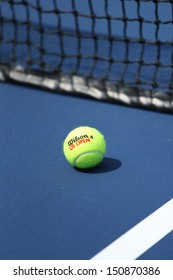 FLUSHING, NY - AUGUST 20: Wilson tennis ball on tennis court at Arthur Ashe Stadium  on August 20, 2013 in Flushing, NY. Wilson is  the Official Ball of the US Open since 1979