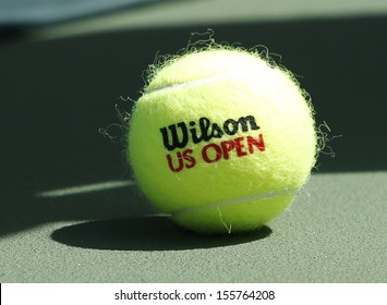 FLUSHING, NY - SEPTEMBER 5: Wilson tennis ball on tennis court at Arthur Ashe Stadium on September 5, 2013 in Flushing, NY. Wilson is the Official Ball of the US Open since 1979