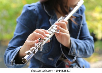 Flute Classical Instrument Player Playing Song. Instructor Practicing Bronze Woodwind For Orchestra As Solo With Green Bokeh Outside With Nature.