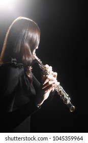 Flute Player. Flutist Playing Flute Music Instrument. Classical Musician Woman Isolated On Black. Focus Is On The Hands