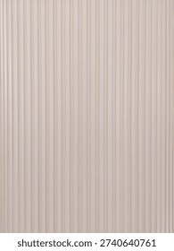 Fluted wall panel surface with soft neutral tones and vertical grooves, for product branding photography, seamless backgrounds, minimalist interior design, modern architecture, and decor projects.