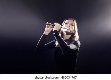 Flutist Playing Flute Piccolo Instrument. Flute Player Woman Musician With Music Instrument