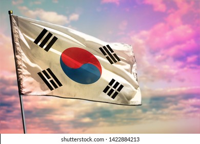 Fluttering Republic of Korea (South Korea) flag on colorful cloudy sky background. Republic of Korea (South Korea) prospering concept.