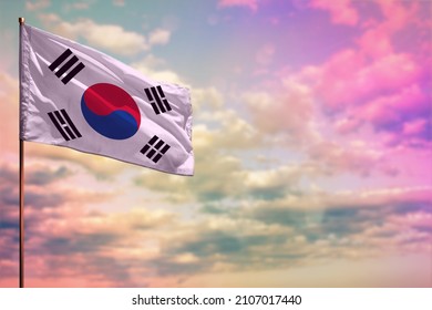 Fluttering Republic of Korea (South Korea) flag mockup with the place for your text on colorful cloudy sky background.