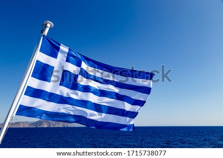 fluttering in the wind Flag of Greece on the ship floats in sea