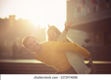  Fly Daddy. Father And Daughter Playing In The City Street.