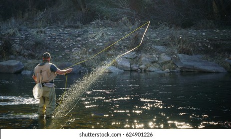 Fly Fisherman Casting on the River