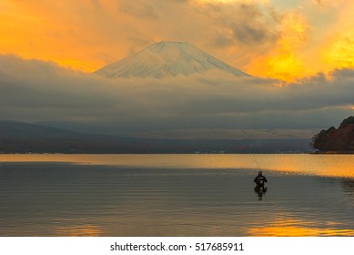 Fly Fisherman Fishing Mt Fuji In Lake Yamanaka.It Is The Sunset At Mount Fuji.