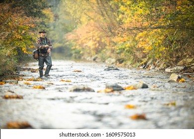 Fly fisherman fly fishing on a splendid mountain river - Powered by Shutterstock