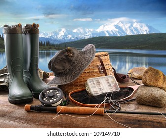 Fly fishing equipment on deck with beautiful view of a lake and mountains