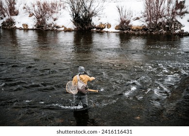 Fly fishing on the dark and icy waters of the Provo River, Provo, Ut. USA - Powered by Shutterstock