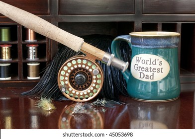 Fly Rod Being Prepared For A Day Of Fly Fishing.  Coffee Mug Indicating The World's Greatest Dad