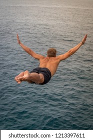 To Fly You Must Jump First , Man Cliff Diving At The Petrovac Fort , Montenegro.