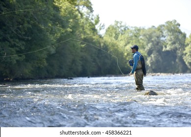 Flyfisherman fishing in mountain river