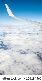 Flying Above The Sea Of Clouds. Features Bright Blue Sky And White Clouds. Slight Curvature Of The Earth At The Horizon.