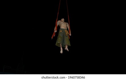 
Flying Acrobat On Black Background, Spider Man, Chinese Circus, Entertainment,  Slings Exercises, Upward Movement, 	Extreme Sport		