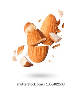 Flying in air fresh raw whole and cut almonds  isolated on white background. Concept of Almonds is torn to pieces close-up. High resolution image